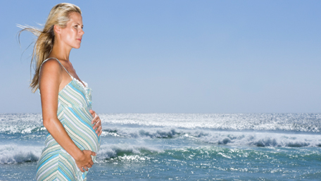 a pregnant woman on the beach
